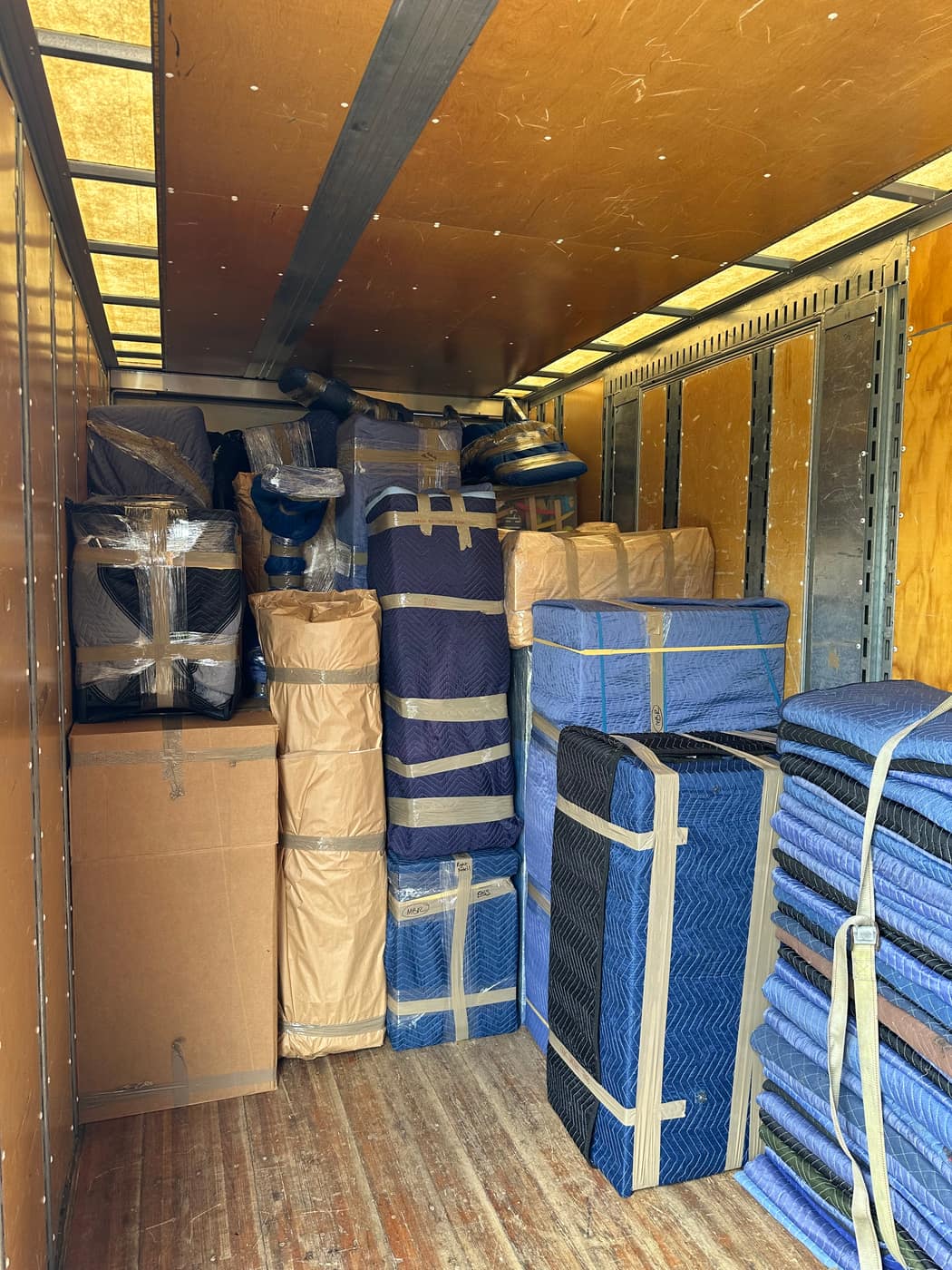 Truck fully loaded with blanket-wrapped furniture