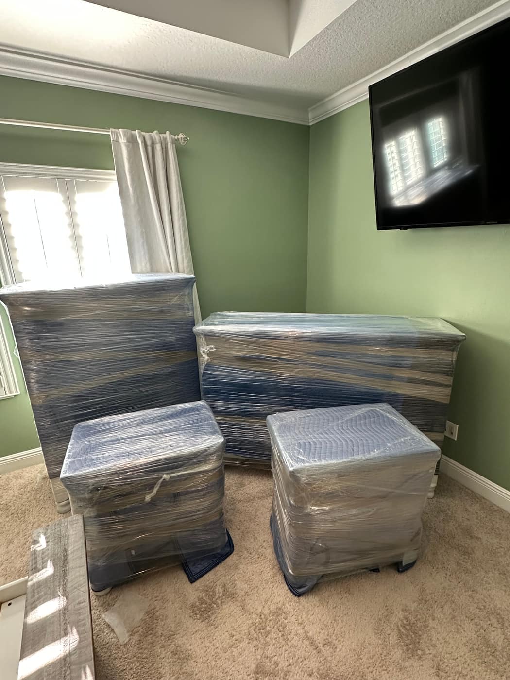Shrink-wrapped furniture staged and ready to go