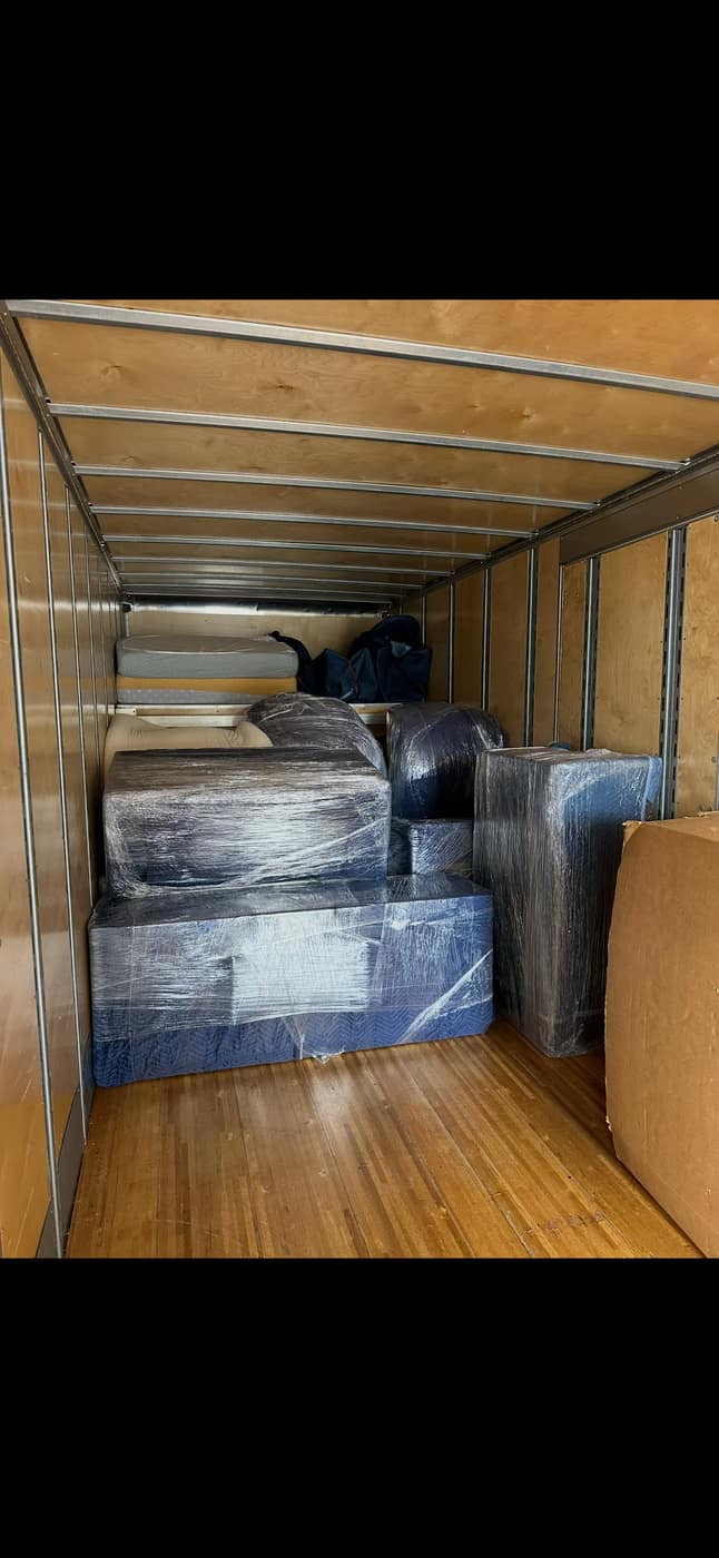 Wrapped furniture secured inside the truck