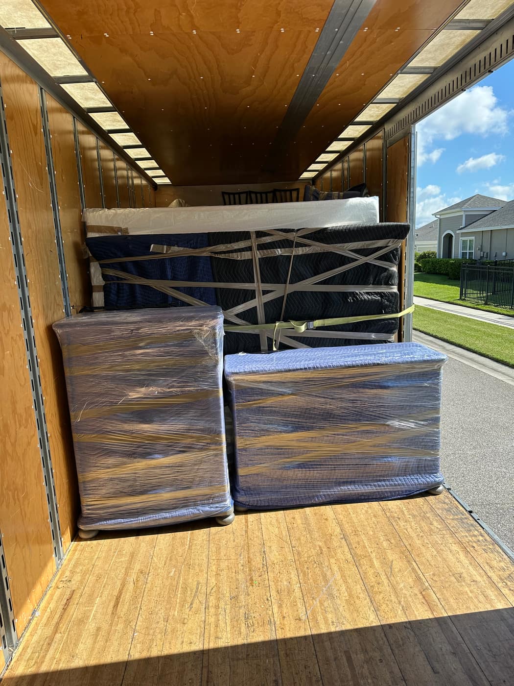 Blanket-wrapped pieces being loaded